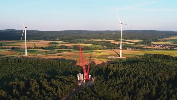 Aerial view of wind turbines and a crane in Hofgeismar Germany.