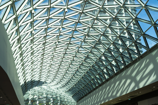 View of the modern curved glass and steel skylight roof of a building with geometric patterns and shadows in Bratislava Bratislava Region Slovakia. View of the modern curved glass and steel skylight roof of a building with geometric patterns and shadows in Bratislava Bratislava Region Slovakia.