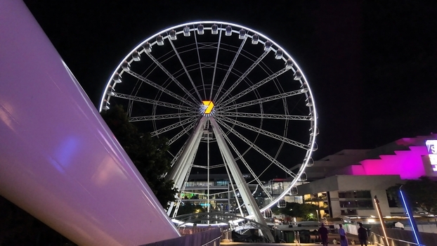 View of the illuminated Wheel of Brisbane ferris wheel at night in Brisbane Queensland Australia. View of the illuminated Wheel of Brisbane ferris wheel at night in Brisbane Queensland Australia.