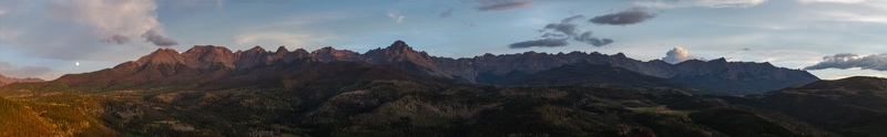 Aerial view of Mount Sneffels and the San Juan Mountains at sunset featuring rugged peaks deep valleys and forested slopes in Ouray County Colorado United States. Aerial view of Mount Sneffels and the San Juan Mountains at sunset featuring rugged peaks deep valleys and forested slopes in Ouray County Colorado United States.