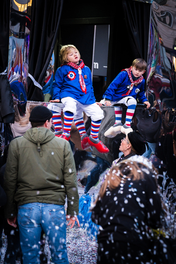 Basel Switzerland 10 March 2025 View of costumed children bright in blue and red perched amidst the Fasnacht revelry a shower of confetti creating a festive atmosphere. Basel Switzerland 10 March 2025 View of costumed children bright in blue and red perched amidst the Fasnacht revelry a shower of confetti creating a festive atmosphere.