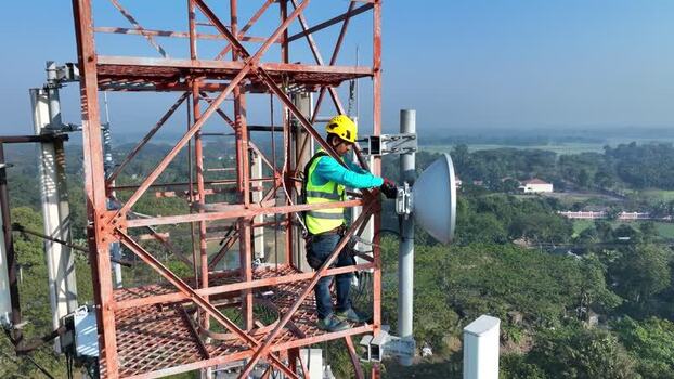 Aerial view of a technician working on a cell tower Bangladesh.