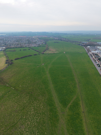 Aerial view of expansive green fields stretching towards the distant horizon where the city meets the sky creating a serene contrast Derby United Kingdom. Aerial view of expansive green fields stretching towards the distant horizon where the city meets the sky creating a serene contrast Derby United Kingdom.