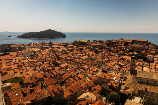 View of the historic terracotta rooftops of the Old Town with Lokrum Island in the background under a clear sky in Dubrovnik Dubrovnik Neretva County Croatia. View of the historic terracotta rooftops of the Old Town with Lokrum Island in the background under a clear sky in Dubrovnik Dubrovnik Neretva County Croatia.