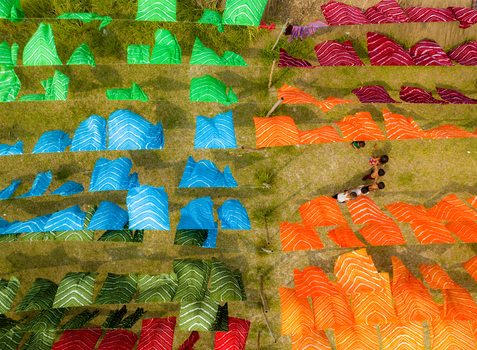 Narayanganj Bangladesh 30 March 2026 Aerial view of vibrant textiles arrayed on the grass a symphony of colour and pattern creating a vivid spectacle.