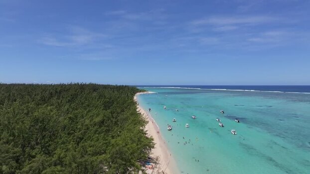 Aerial view of Le Morne beach with boats and turquoise water Mauritius.