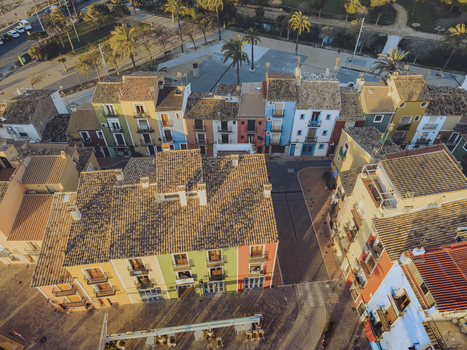 Aerial view of the iconic colorful houses and tiled rooftops surrounding a town square in the historic center of La Vila Joiosa Valencian Community Spain. Aerial view of the iconic colorful houses and tiled rooftops surrounding a town square in the historic center of La Vila Joiosa Valencian Community Spain.