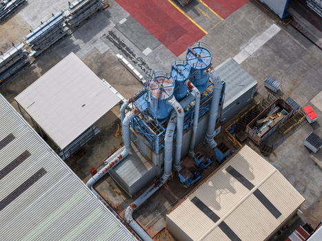 Aerial view of industrial machinery and blue filtration towers at a manufacturing facility in Melbourne VIC Australia.
