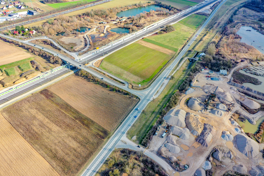 Aerial view of a highway interchange and railway line passing through agricultural fields and a gravel quarry in Buttenheim Bavaria Germany. Aerial view of a highway interchange and railway line passing through agricultural fields and a gravel quarry in Buttenheim Bavaria Germany.