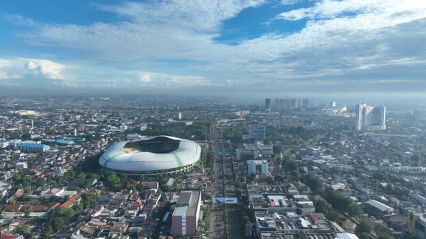 Bekasi Barat Indonesia 12 April 2026 Aerial view of Patriot Candrabhaga Stadium surrounded by dense urban housing roads and lush greenery under a bright blue sky. Bekasi Barat Indonesia 12 April 2026 Aerial view of Patriot Candrabhaga Stadium surrounded by dense urban housing roads and lush greenery under a bright blue sky.