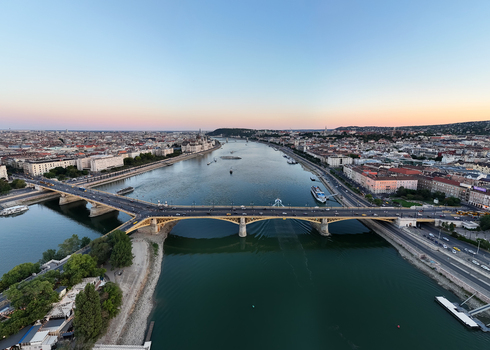 Aerial view of Margaret Bridge over the Danube with the Hungarian Parliament riverboats and evening traffic along the waterfront in Budapest Hungary. Aerial view of Margaret Bridge over the Danube with the Hungarian Parliament riverboats and evening traffic along the waterfront in Budapest Hungary.