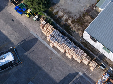 Melbourne VIC Australia 22 September 2026 Aerial view of wooden pallets stacked in an industrial yard next to a factory building in Kilsyth. Melbourne VIC Australia 22 September 2026 Aerial view of wooden pallets stacked in an industrial yard next to a factory building in Kilsyth.