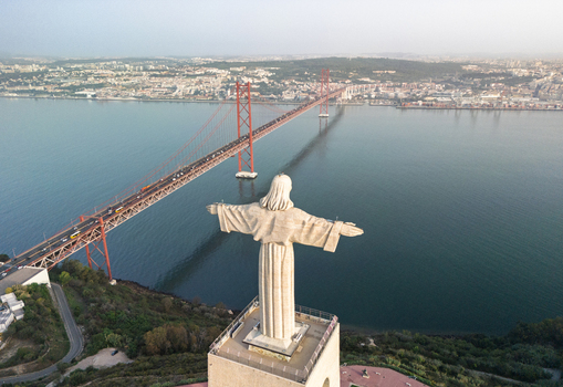 Aerial view of the Cristo Rei statue overlooking the 25 de Abril Bridge and the Tagus River in Lisbon Lisbon Portugal.