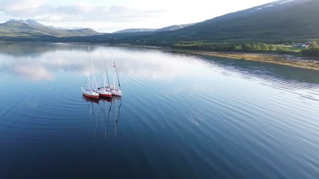 Aerial view of sailboats in a calm fjord in Senja Norway. Aerial view of sailboats in a calm fjord in Senja Norway.