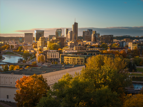 Aerial view of the skyscrapers piercing the skyline beyond the autumnal trees and the winding river Neris Vilnius Lithuania. Aerial view of the skyscrapers piercing the skyline beyond the autumnal trees and the winding river Neris Vilnius Lithuania.