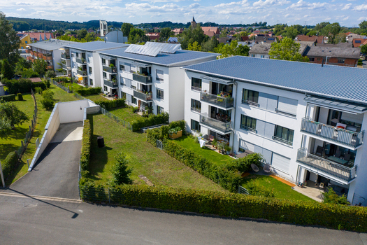 Aerial view of modern residential apartment buildings with solar panels on roofs and green gardens in Erlangen Bavaria Germany.