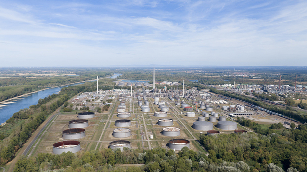 Aerial view of the Mineralolraffinerie Oberrhein oil refinery complex with storage tanks industrial infrastructure and tall chimneys along the Rhine river Karlsruhe Baden Wurttemberg Germany. Aerial view of the Mineralolraffinerie Oberrhein oil refinery complex with storage tanks industrial infrastructure and tall chimneys along the Rhine river Karlsruhe Baden Wurttemberg Germany.
