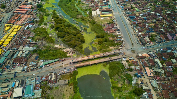 Aerial view of the bridge crossing the river amidst the dense urban landscape reflecting a mix of residential and commercial buildings Abeokuta Ogun State Nigeria.