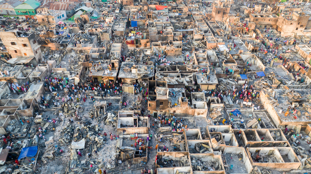 Aerial view of the aftermath of devastation with people amidst the rubble a stark contrast of human presence against the grey ruins Dhaka Dhaka Division Bangladesh. Aerial view of the aftermath of devastation with people amidst the rubble a stark contrast of human presence against the grey ruins Dhaka Dhaka Division Bangladesh.