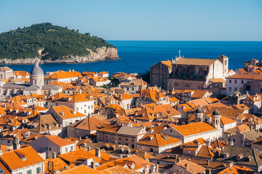 View of the historic orange terracotta rooftops of Dubrovnik Old Town with the blue Adriatic Sea and Lokrum island in the background Dubrovnik Dubrovnik Neretva County Croatia. View of the historic orange terracotta rooftops of Dubrovnik Old Town with the blue Adriatic Sea and Lokrum island in the background Dubrovnik Dubrovnik Neretva County Croatia.