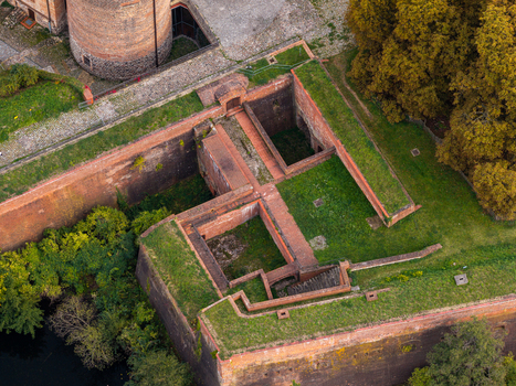 Aerial view of the historic brick fortifications of Spandau Citadel featuring grassy ramparts deep moats and surrounding trees in Berlin Berlin Germany.