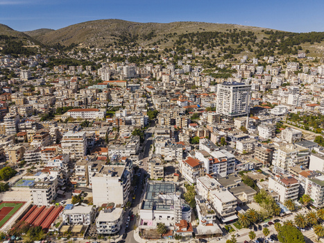 Aerial view of the coastal city of Saranda with its dense urban landscape residential buildings and surrounding hills in Saranda Vlore County Albania. Aerial view of the coastal city of Saranda with its dense urban landscape residential buildings and surrounding hills in Saranda Vlore County Albania.