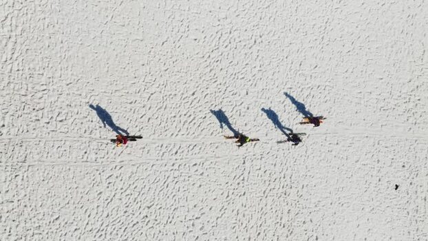 Aerial view of people walking on snow near Rifugio Sapienza Italy. Aerial view of people walking on snow near Rifugio Sapienza Italy.