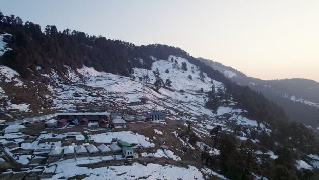 Aerial view of Chopta Tungnath campsite in snowy mountains India.