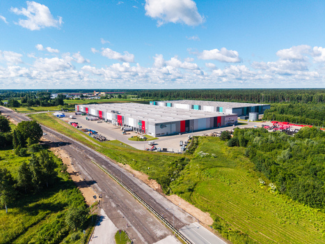 Lielvarzi Latvia 05 July 2026 Aerial view of VGP Park Kekava Warehouse with large industrial buildings loading docks surrounding green fields and a nearby road under a blue sky with clouds. Lielvarzi Latvia 05 July 2026 Aerial view of VGP Park Kekava Warehouse with large industrial buildings loading docks surrounding green fields and a nearby road under a blue sky with clouds.