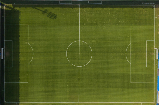 Aerial view of a green soccer field with white markings and goal posts in Istanbul Istanbul Turkiye.