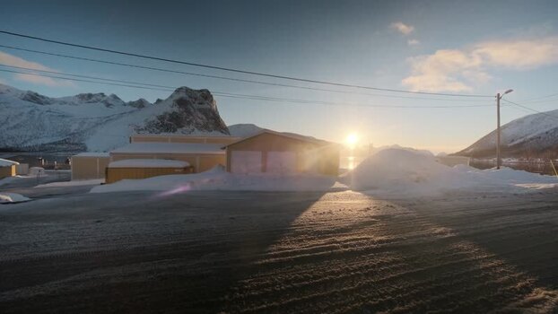 View of snowy buildings and mountains in Indreg&aring;rd Norway.