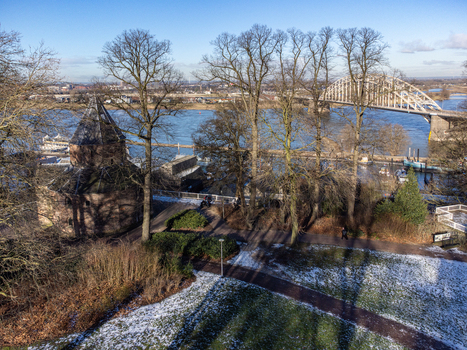 Aerial view of the Valkhofpark s ancient architecture contrasting with the modern Waalbrug bridge over the serene Waal river Nijmegen Gelderland Netherlands. Aerial view of the Valkhofpark s ancient architecture contrasting with the modern Waalbrug bridge over the serene Waal river Nijmegen Gelderland Netherlands.