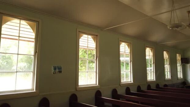 View of a simple church interior with wooden pews Pitcairn Islands.
