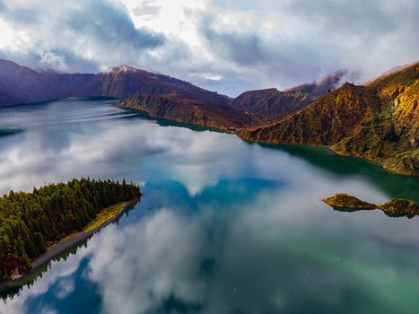 Aerial view of Lagoa do Fogo crater lake with dramatic cloud reflections on the water surface and lush green volcanic slopes Agua de Alto Azores Portugal. Aerial view of Lagoa do Fogo crater lake with dramatic cloud reflections on the water surface and lush green volcanic slopes Agua de Alto Azores Portugal.