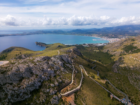 Aerial view of the winding road of Cap de Formentor through rugged mountains overlooking the Mediterranean coast Balearic Islands Spain.