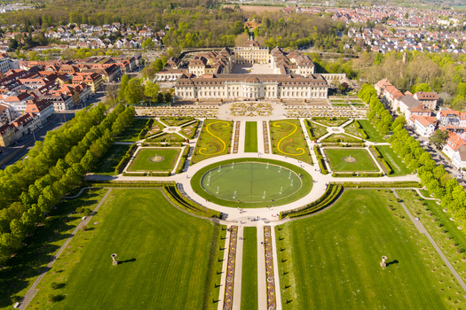 Aerial view of the baroque Ludwigsburg Palace surrounded by meticulously manicured gardens a large circular fountain and the historic cityscape of Ludwigsburg Baden Wurttemberg Germany.