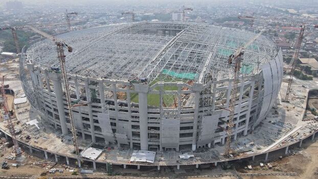 Aerial view of Jakarta International Stadium under construction with cranes and structural steel framework in Tanjung Priok Jakarta Indonesia. Aerial view of Jakarta International Stadium under construction with cranes and structural steel framework in Tanjung Priok Jakarta Indonesia.