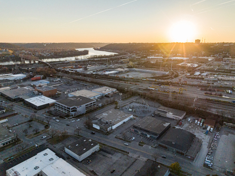 Aerial view of buildings and roads basking in the warm glow of the setting sun with a river snaking through the landscape Nashville United States. Aerial view of buildings and roads basking in the warm glow of the setting sun with a river snaking through the landscape Nashville United States.