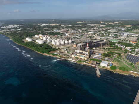 Aerial view of the industrial complex with large storage tanks and power plant facilities along the coastline in Bajos de Haina San Cristobal Province Dominican Republic.
