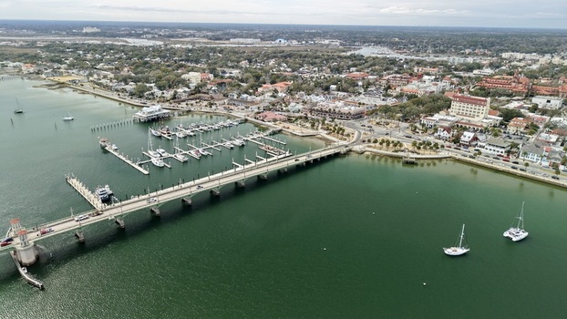 Aerial view of the Bridge of Lions and the municipal marina with sailboats moored in the Matanzas River under a clear sky in St. Augustine Florida United States.