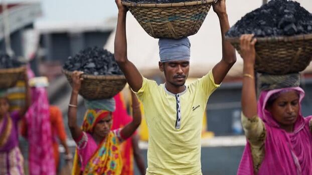 View of workers carrying coal baskets in Aminbazar Bangladesh. View of workers carrying coal baskets in Aminbazar Bangladesh.