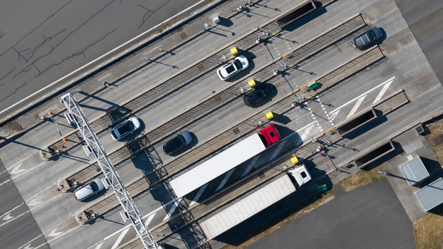 Aerial view of the Gare de Peage de Dury toll plaza with cars and a truck passing through the lanes in Saleux Hauts de France France.