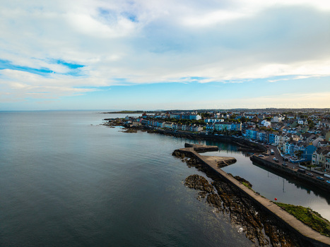 Aerial view of Bangor Harbour and Town with colorful coastal buildings rocky shoreline and calm sea in Bangor Northern Ireland United Kingdom.
