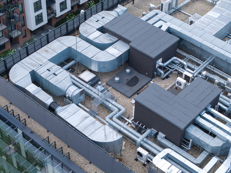 Aerial view of industrial cooling system and HVAC ductwork installed on a building rooftop in Krakow Lesser Poland Voivode Poland.