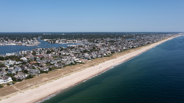 Aerial view of the sandy beach residential homes and marina along the Atlantic Ocean in Mantoloking New Jersey United States.