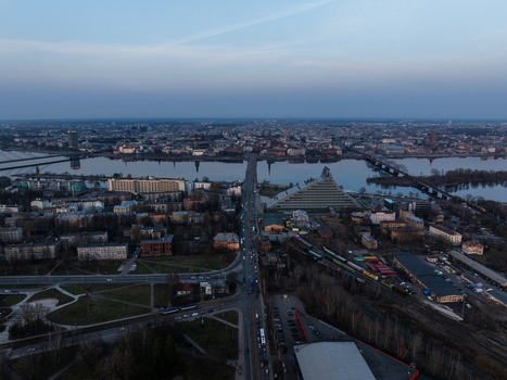Aerial view of the Daugava River with the Akmens tilts bridge and the National Library of Latvia looking towards the historic Old Riga skyline in Riga Latvia. Aerial view of the Daugava River with the Akmens tilts bridge and the National Library of Latvia looking towards the historic Old Riga skyline in Riga Latvia.