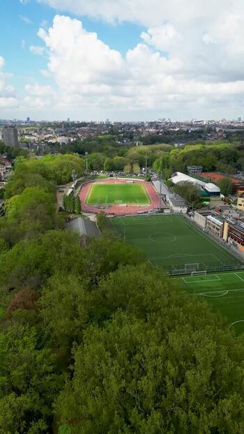 Aerial view of a sports stadium and green fields in Brussels Belgium.