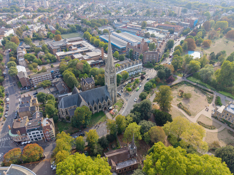 Aerial view of St Mary s Church in Stoke Newington surrounded by lush trees historic residential buildings and urban streets in London England United Kingdom. Aerial view of St Mary s Church in Stoke Newington surrounded by lush trees historic residential buildings and urban streets in London England United Kingdom.