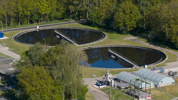 Aerial view of the RWZI Echten wastewater treatment plant with circular clarifier tanks and green trees in Hoogeveen Drenthe Netherlands. Aerial view of the RWZI Echten wastewater treatment plant with circular clarifier tanks and green trees in Hoogeveen Drenthe Netherlands.