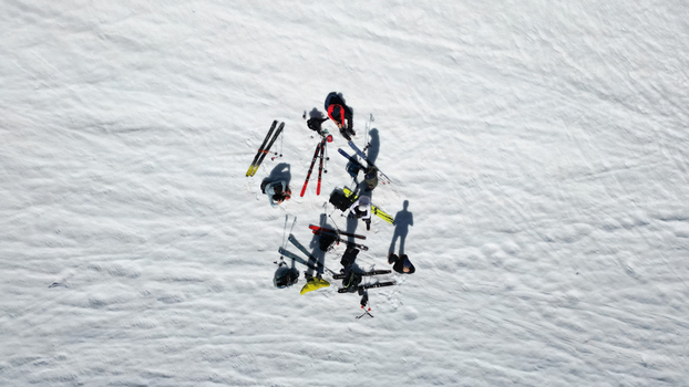 Aerial view of a group of skiers resting with their equipment on the snowy slopes of Pointe Ronde near Trient Valais Switzerland.